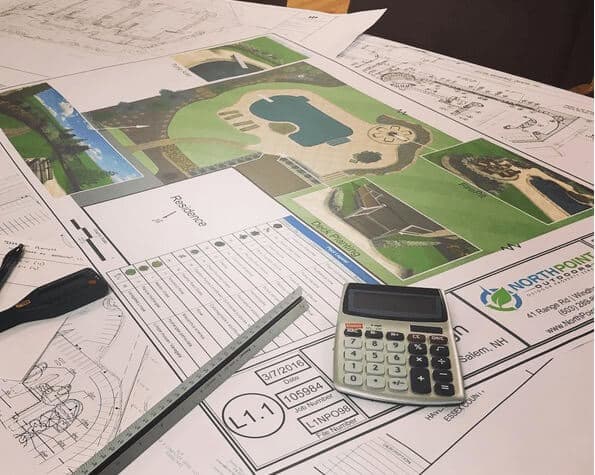 Landscape design plan, calculator and ruler spread out on desk