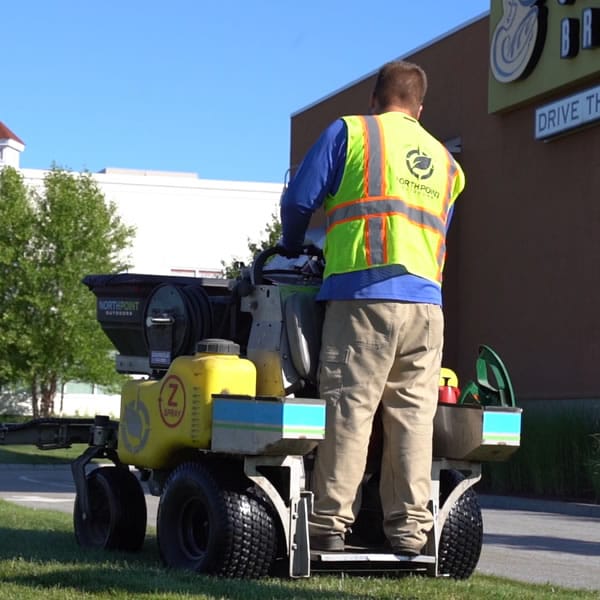 Lawn fertilization machine being run by North Point employee